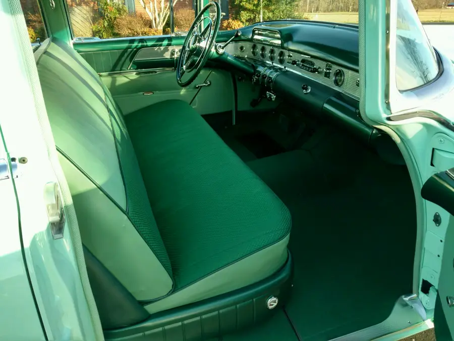 A mint restored car interior, wide finished cabin view.