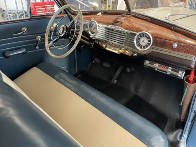 A restored blue vintage interior, wide cabin angle.