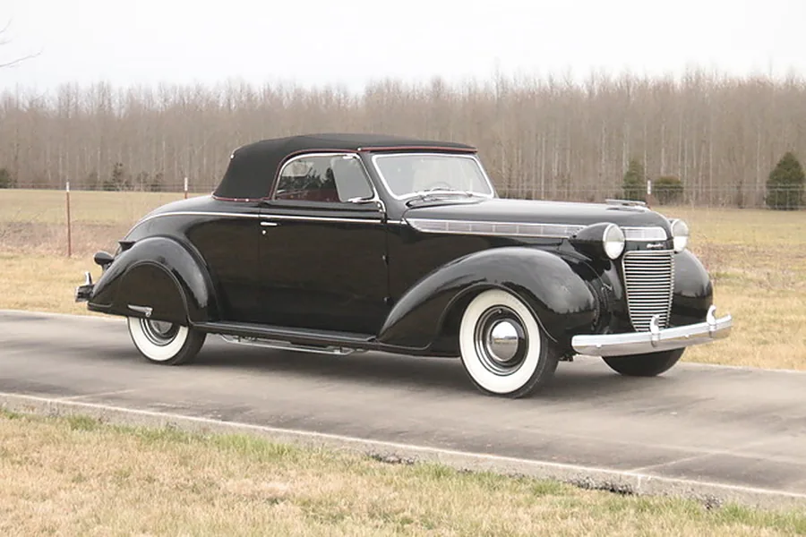 The restored 1937 Chrysler Imperial &ldquo;Black Betty&rdquo; in black, top up, front three-quarter.