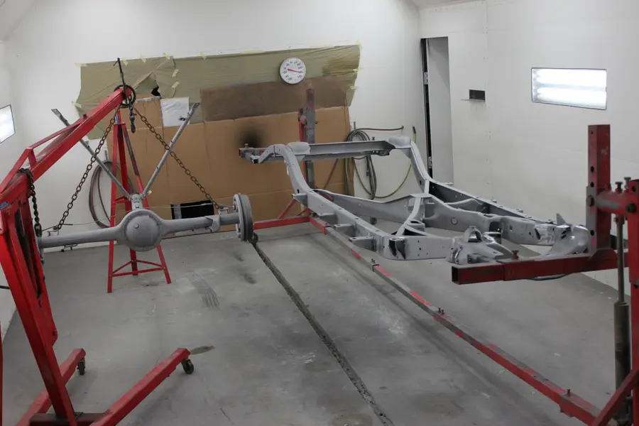 A freshly painted chassis frame in the booth.