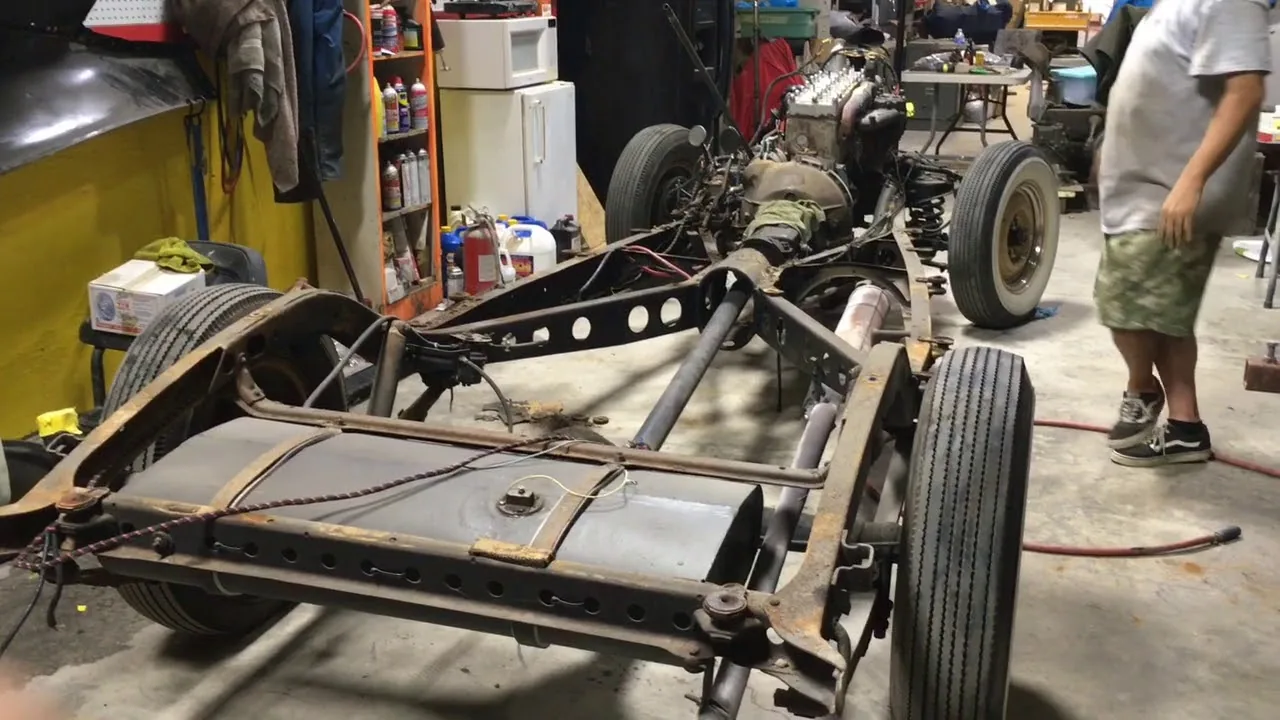 Black Betty's bare chassis off the frame on the shop floor, body removed.